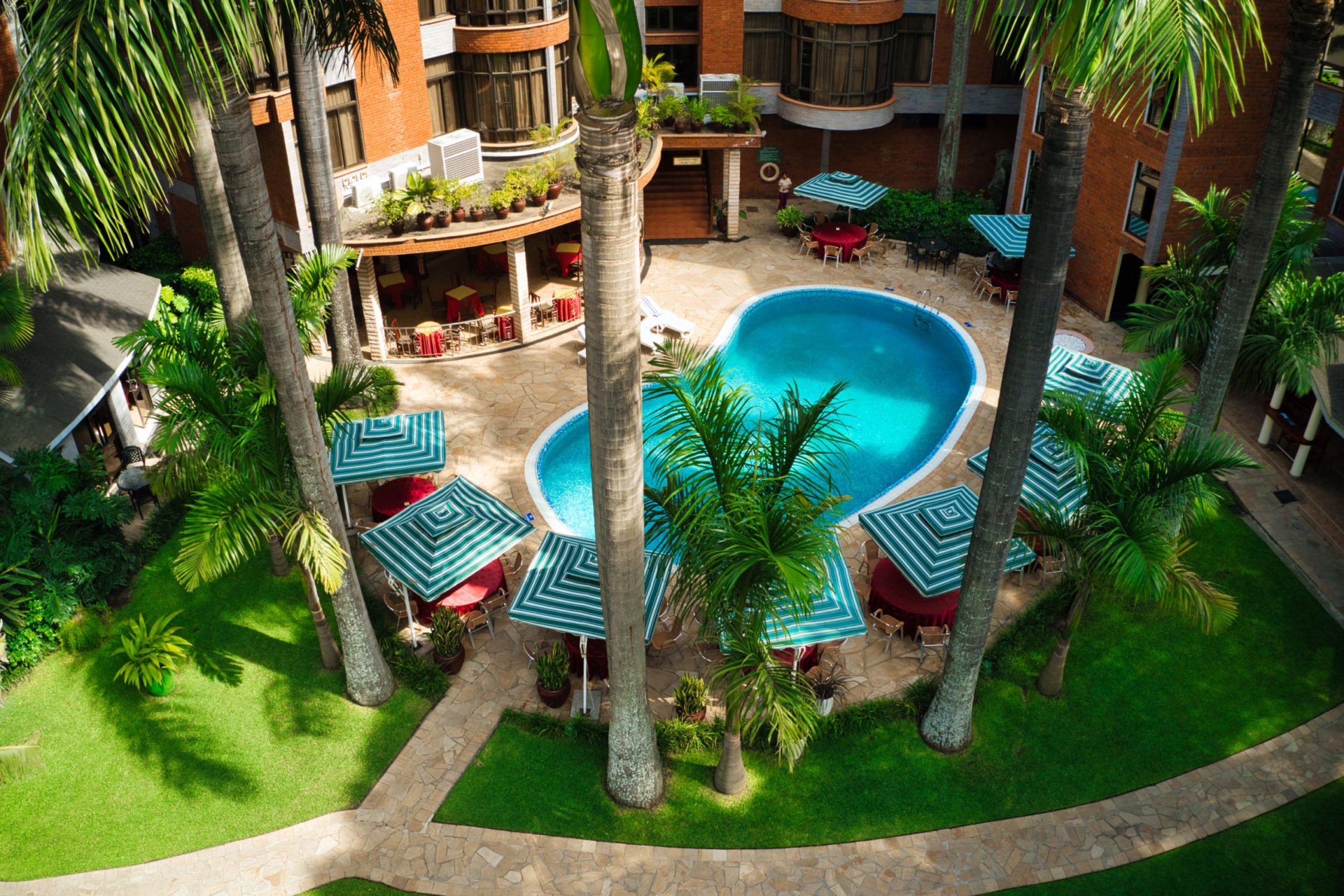 Pool and palm garden seen from above at Kibo Palace Hotel Arusha